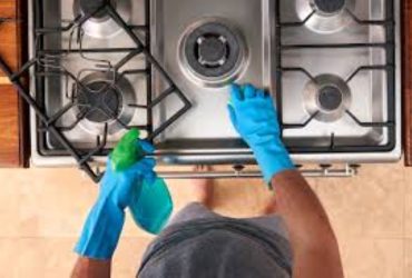 How do you clean between oven and cabinets?