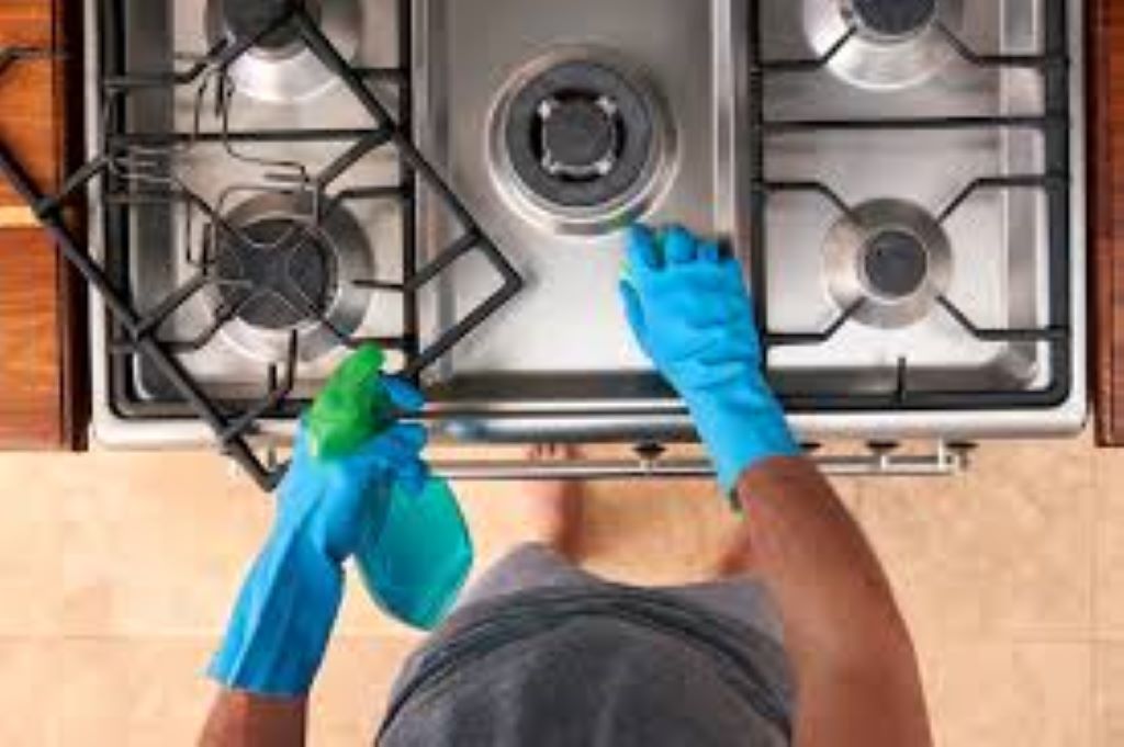 How do you clean between oven and cabinets?