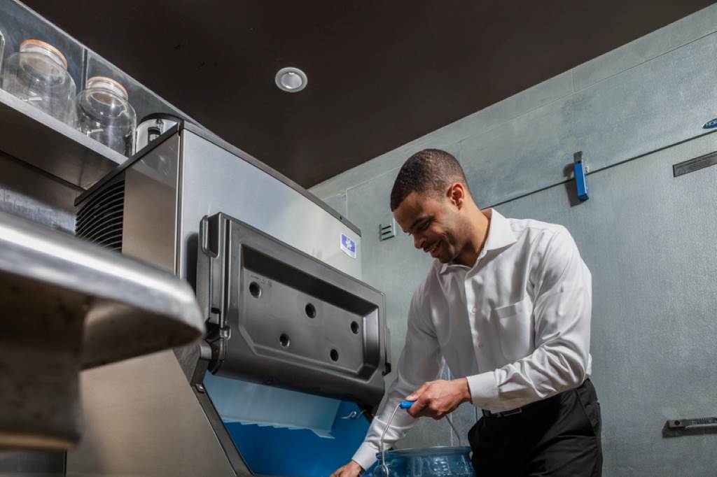 Maintenance technician servicing professional ice machine