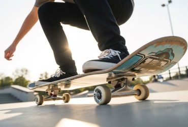 Beginner skateboarder demonstrating proper foot placement and stance on skateboard deck