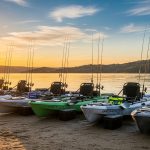 Wide fishing kayak designed for big anglers standing and casting on calm lake