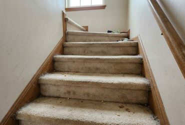 Chicago townhome staircase being cleaned with vacuum attachment
