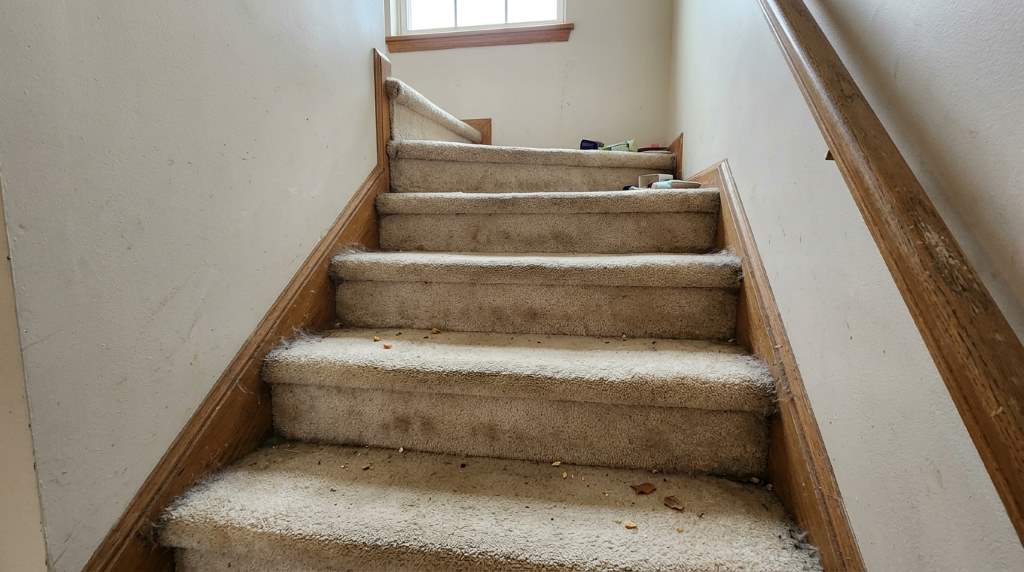 Chicago townhome staircase being cleaned with vacuum attachment