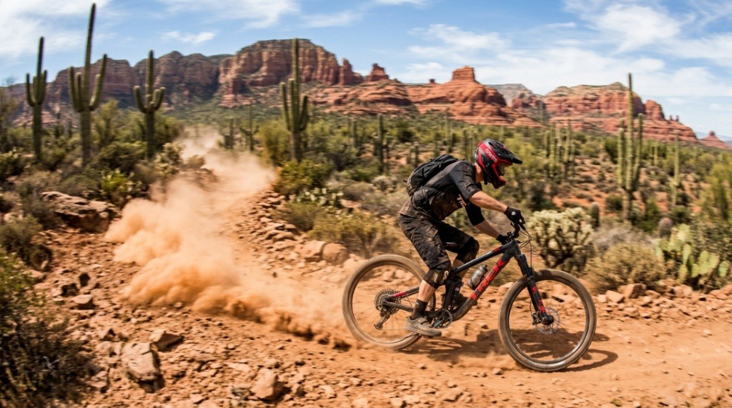 Mountain bike chain coated in desert dust with crisp sunlight highlighting the links.