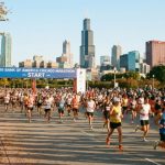 Thousands of runners crossing the start line in Grant Park at the 2026 Bank of America Chicago Marathon on a crisp October morning in Chicago