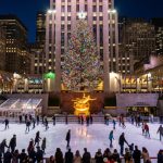 Rockefeller Center Christmas tree lit up at night above the ice rink
