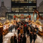 Wooden market stalls decorated with holiday lights at Christkindlmarket Chicago Daley Plaza in winter 2026
