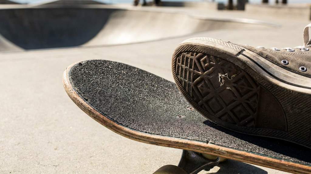 Skater practicing tricks on rough Los Angeles pavement